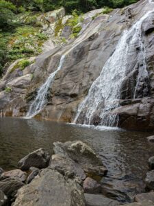 Waterfall cascading over rocky terrain.