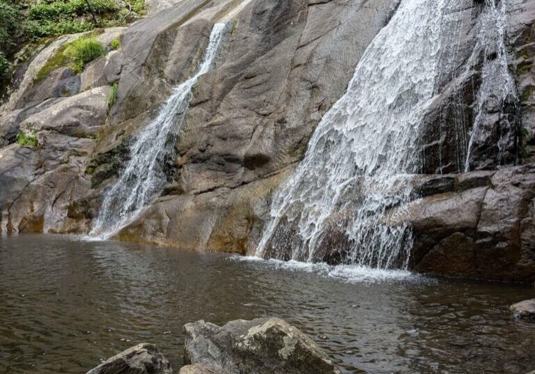 Waterfall cascading over rocky terrain.